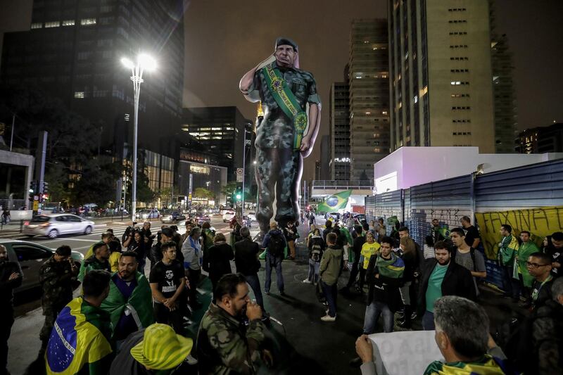 Supporters of presidential candidate Jair Bolsonaro install a giant inflatable doll with the image of General Hamilton Mourao, Vice President candidate of Bolsonaro on Avenida Paulista in Sao Paulo, Brazil. EPA