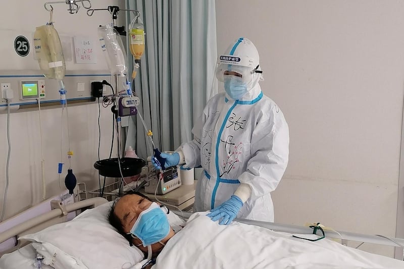 In this photo released by Chinese nurse Zhang Dan, she looks after a patient being treated for Covid-19 at the Tongji hospital in Wuhan in central China's Hubei province. AP