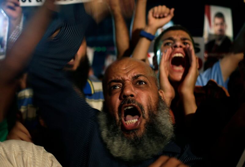 Supporters of Egypt's ousted President Mohammed Morsi chant slogans against Egyptian Defense Minister Gen. Abdel-Fattah el-Sissi at Nasr City, where protesters have installed a camp and hold daily rallies, in Cairo, Egypt, Sunday, July 28, 2013. Deadly clashes broke out during funerals of slain supporters of Egypt's ousted Islamist president Sunday, as the supreme leader of the Muslim Brotherhood urged his followers to stand fast after more than 80 of them were killed in weekend violence. (AP Photo/Hassan Ammar) *** Local Caption ***  Mideast Egypt.JPEG-09c7d.jpg