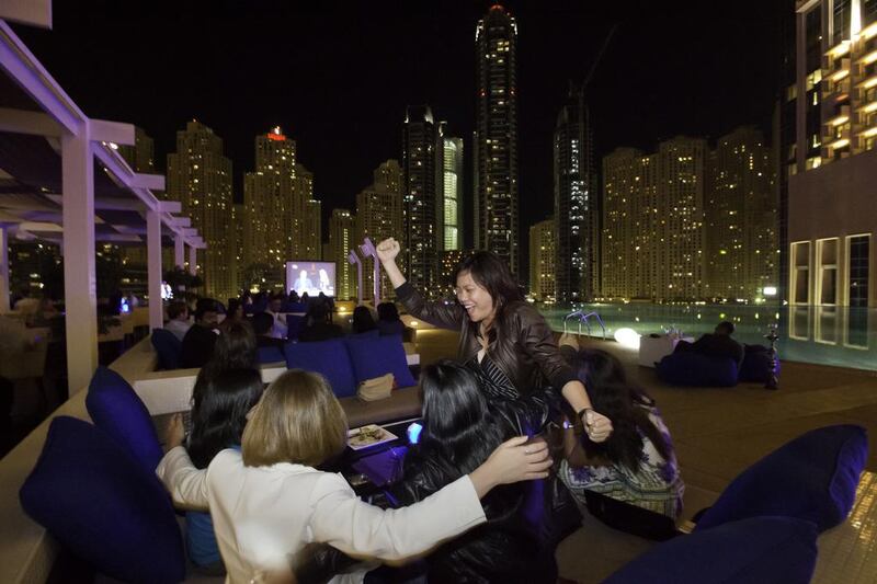 People celebrate Dubai's victory at The Shades Lounge at The Address Hotel in Dubai Marina. Jaime Puebla / The National