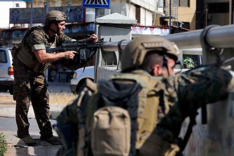 Lebanese security forces react to gunfire.