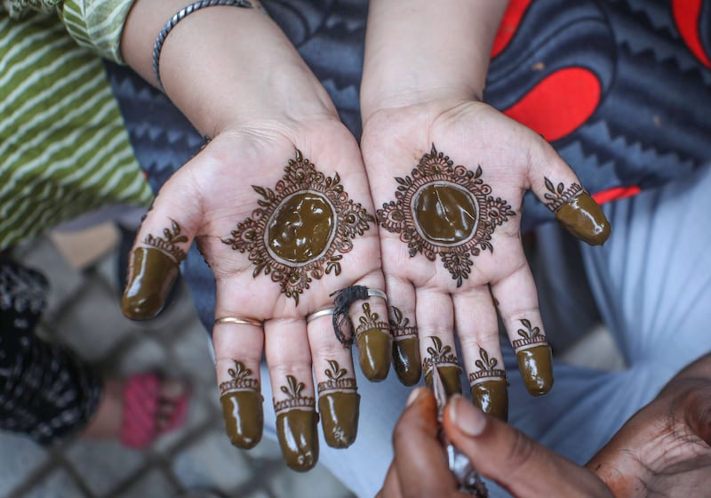 A Kashmiri girl has her hands decorated with henna ahead of Eid Al Adha, in Srinagar, the summer capital of Indian-administered Jammu and Kashmir region. EPA