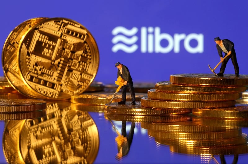 FILE PHOTO: FILE PHOTO: Small toy figures are seen on representations of virtual currency in front of the Libra logo in this illustration picture, June 21, 2019. REUTERS/Dado Ruvic/File Photo