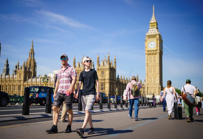 A sunshine stroll near the Houses of Parliament in London. PA