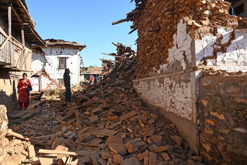 Residents inspect damaged houses in the aftermath of a 5.6 magnitude earthquake in Jajarkot district in Nepal on November 4, 2023. AFP