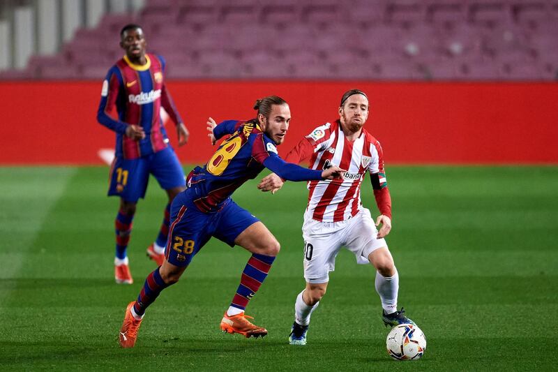 BARCELONA, SPAIN - JANUARY 31: Oscar Mingueza of FC Barcelona battles for the ball with Iker Muniain of Athletic Club during the La Liga Santander match between FC Barcelona and Athletic Club at Camp Nou on January 31, 2021 in Barcelona, Spain. Sporting stadiums around Spain remain under strict restrictions due to the Coronavirus Pandemic as Government social distancing laws prohibit fans inside venues resulting in games being played behind closed doors. (Photo by Alex Caparros/Getty Images)