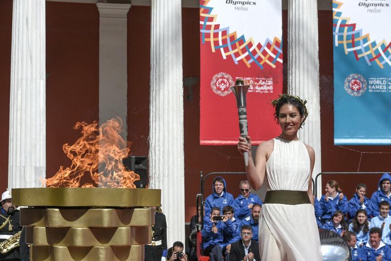 Iliana Symeonidou, High Priestess and Special Olympics Hellas athlete lighting the cauldron.