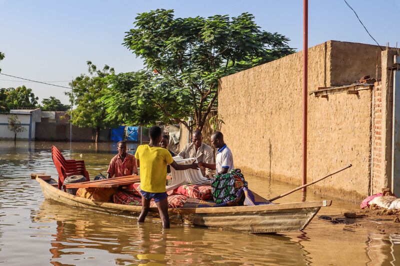 Residents try to salvage items from houses submerged by floods in N'Djamena, Chad, on October 18, 2022. AFP