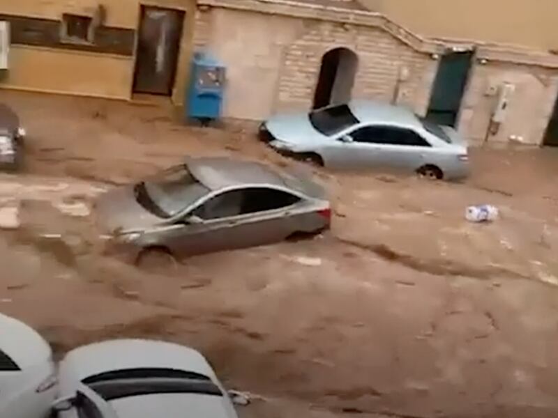 A screengrab from a video shows cars being swept down a street in Jeddah.