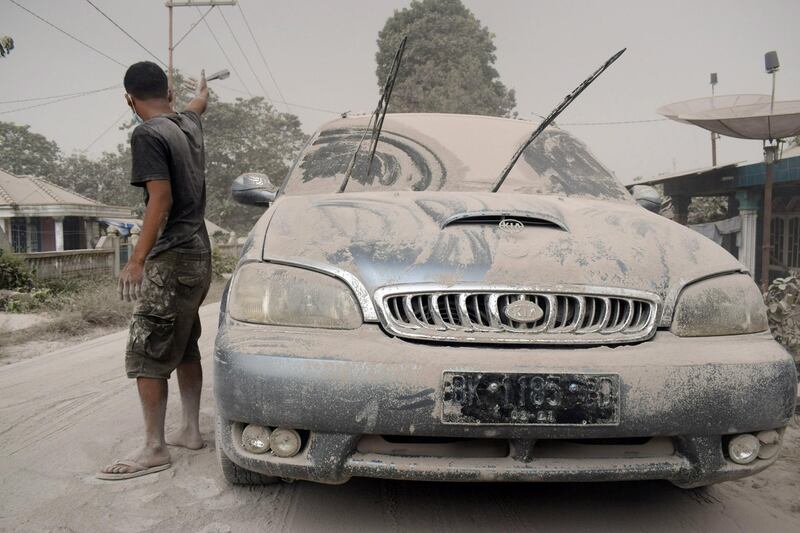Ash from Mount Sinabung volcano covers a car and street following an eruption in Karo, North Sumatra, Indonesia. Antara Foto / Surianto Sembiring / via Reuters