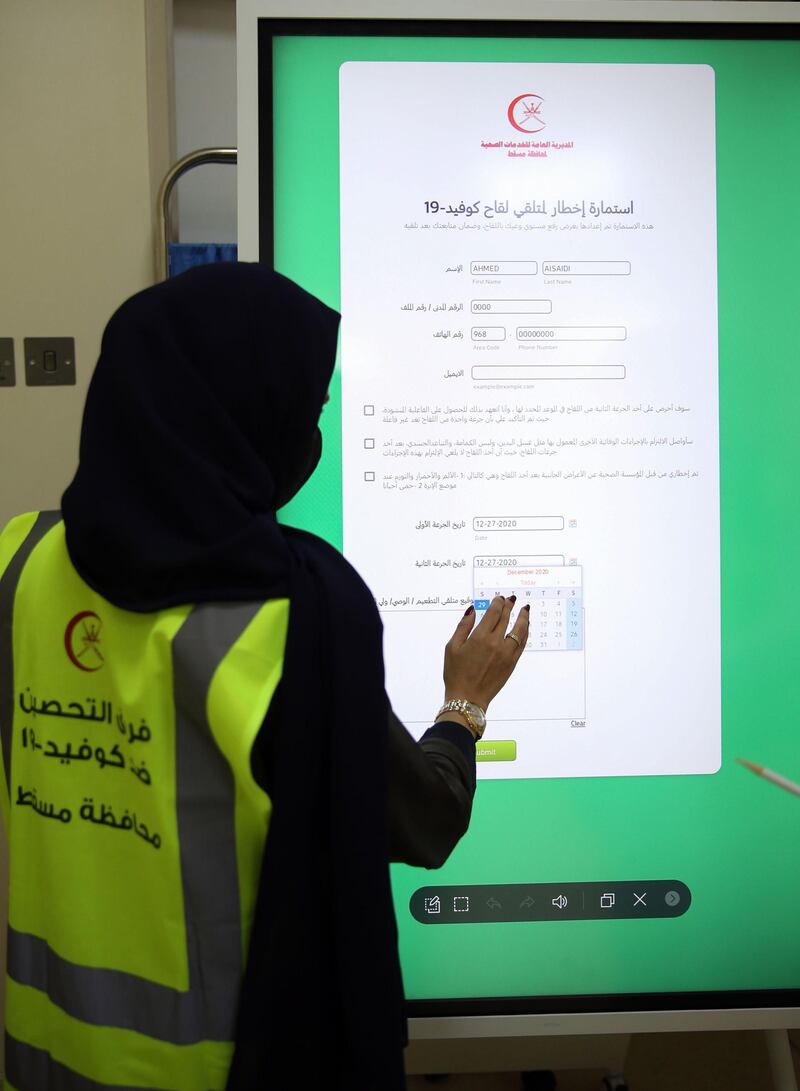 A healthcare worker fills in the Covid-19 vaccine form in the Omani capital Muscat.  AFP