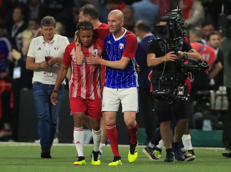 Zinedine Zidane of the France 98 team and FIFA 98’s Edgar Davids congratulate each other at the end of the match. Zidane and Davids formed a formidable midfield partnership at Juventus in the 90s. Gonzalo Fuentes / Reuters