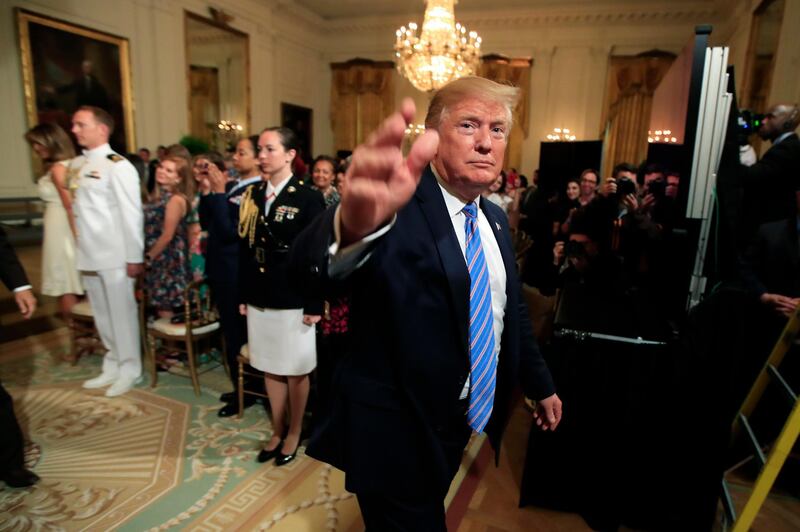 President Donald Trump waves as he leaves the East Room during a celebration of military mothers with first lady Melania Trump at the White House in Washington, Friday, May 10, 2019. (AP Photo/Manuel Balce Ceneta)
