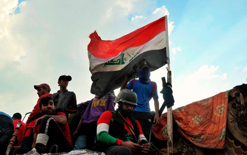 Protesters stage a sit-in on barriers at the Ahrar Bridge during ongoing anti-government protests in Baghdad, Iraq. AP Photo