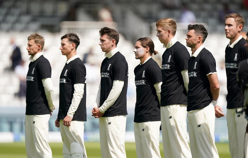 England players stand wearing t-shirts displaying anti-racism message before the start of play. PA