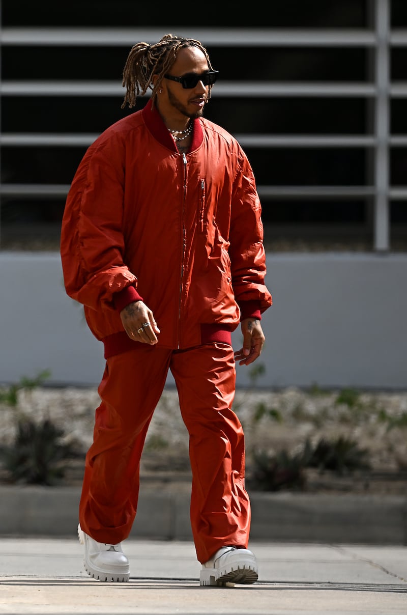 Lewis Hamilton, in an oversized Isabel Marant red tracksuit, in the paddock ahead of the Bahrain Grand Prix at Bahrain International Circuit on March 17, 2022. Getty Images