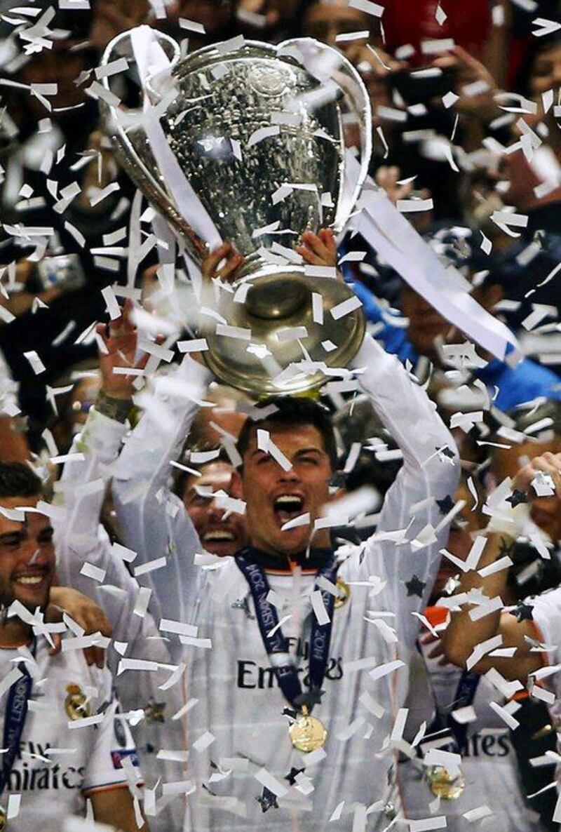 Real Madrid's Cristiano Ronaldo, centre, and his teammates celebrate with the trophy after their victory in the Champions League final. Mario Cruz / EPA / May 24, 2014