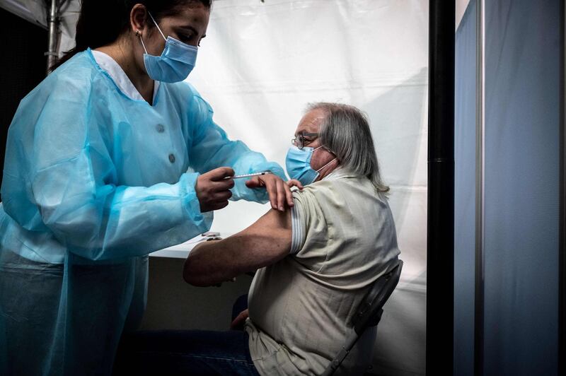 A patient receives the Pfizer/BioNTech vaccine at the Palais des Sports venue in Lyon, France. AFP