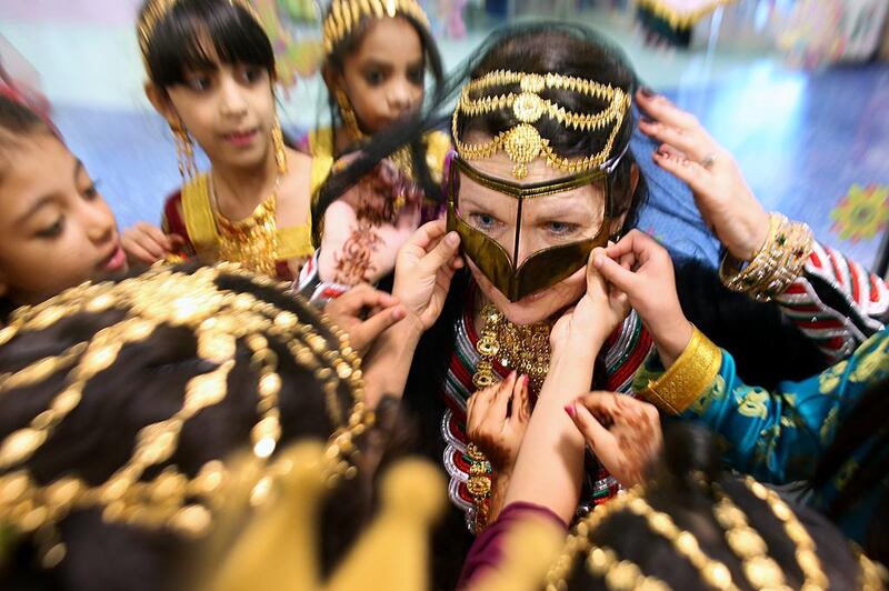 Cheri Sanchez, the principal at the Mubarak bin Mohammed School in Abu Dhabi, was dressed in traditional local costume by her local staff in celebration of UAE National Day. Delores Johnson / The National