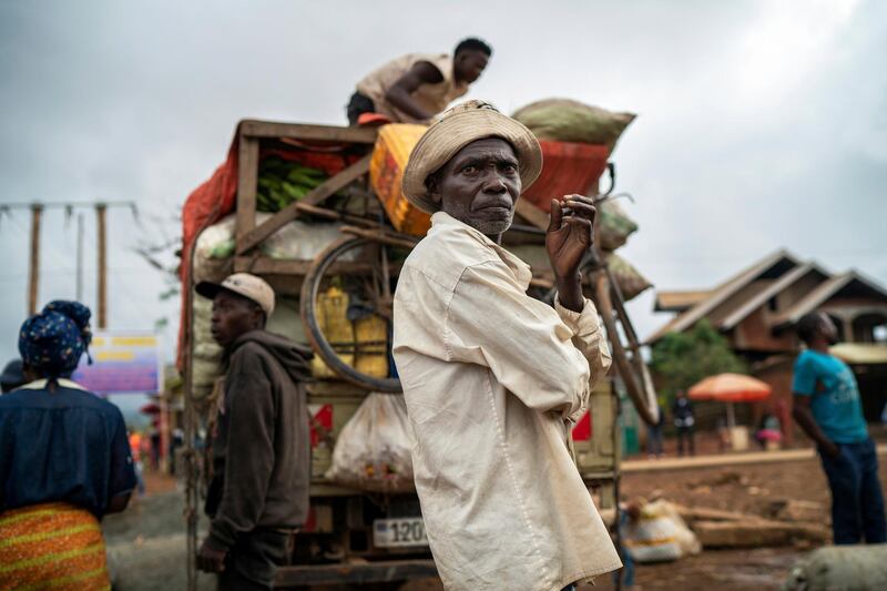 In this Thursday, July 11, 2019 photo, travelers unload goods from a truck they rode into Beni, Congo, the epicenter of the current Ebola epidemic. Deep distrust and pernicious rumors - along with political instability and violence â€“ are severely undermining efforts by public health authorities to trace and vaccinate those who may have come into contact with infected people. (AP Photo/Jerome Delay)