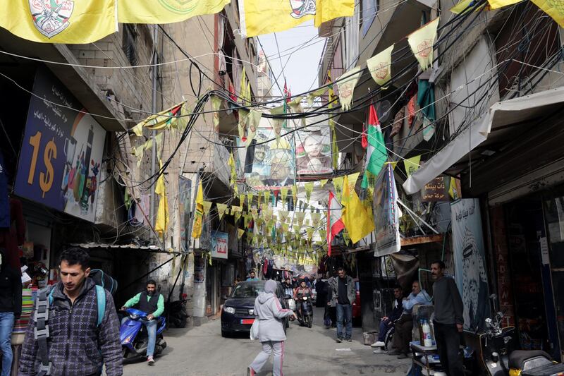 A picture taken on December 21, 2017 shows a view of posters showing Palestinian leaders and Fatah flags hanging in a street in the Burj al-Barajneh camp, a southern suburb of the Lebanese capital Beirut.
More than 174,000 Palestinian refugees live in Lebanon, authorities announced on December 21, in the first-ever census of its kind for a country where demographics have long been a sensitive subject.
The census was carried out by the government's Lebanese-Palestinian Dialogue Committee in 12 Palestinian camps as well as 156 informal "gatherings" across the country. / AFP PHOTO / ANWAR AMRO