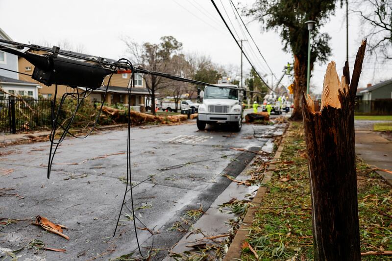 A Sacramento Municipal Utility crew rushes to repair a storm-shattered power pole and hanging wires. Reuters