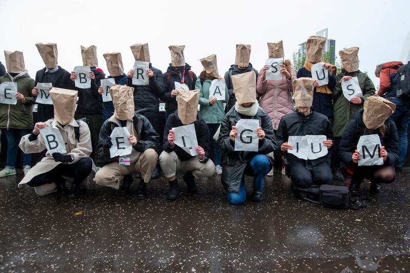 Activists hold placards forming the slogan 'You embarrass us Belgium' during a protest outside the Cop26 venue. EPA
