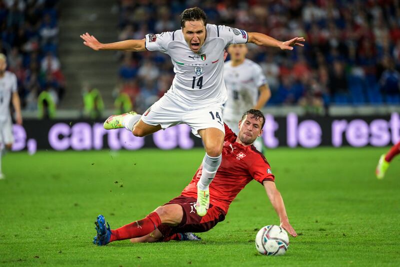 Italy's Federico Chiesa, left, fights for the ball against Switzerland's Fabian Frei during the World Cup 2022 Group C qualifying match at the St Jakob-Park Stadium in Basel, Switzerland, on Sunday, September  5, 2021. AP