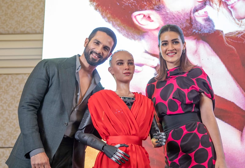 Bollywood stars Shahid Kapoor and Kriti Sanon with humanoid robot Sophia at a press conference in Dubai. Leslie Pableo for The National