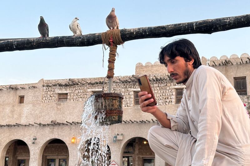 A man relaxes next to a water fountain outside Qatar's Souq Waqif bazar in Doha. AFP