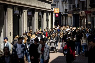 Customers walk on Kalverstraat shopping street in Amsterdam as stores allow shoppers to enter without an appointment, as part of the easing-up measures implemented by the Dutch government. AFP