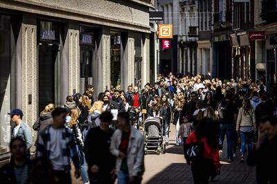 Customers walk on Kalverstraat shopping street in Amsterdam on April 28, 2021, as stores can welcome people again without an appointment, as part of the easing-up measures implemented by the Dutch government following heavy restrictions put in place to curb the spread of the Covid-19.   - Netherlands OUT
 / AFP / ANP / Remko de Waal
