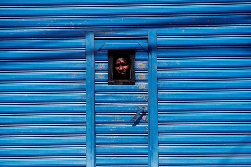 A migrant looks out a window at the General Migration shelter in zone five of Guatemala City, Guatemala. EPA