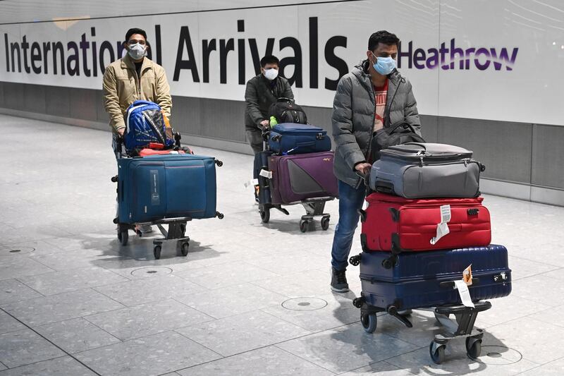 epa08945848 Travellers in the international arrival area of Heathrow Airport, near London, Britain, 18 January 2021. Travel corridors in the the UK were closed at 04:00 hours on 18 January 2021 as British government declared. Travellers arriving to England from anywhere outside the UK have to to self-isolate for 10 days and must have proof of a negative coronavirus test. Britain's national health service (NHS) is coming under sever pressure as Covid-19 hospital admissions continue to rise across the UK.  EPA/NEIL HALL