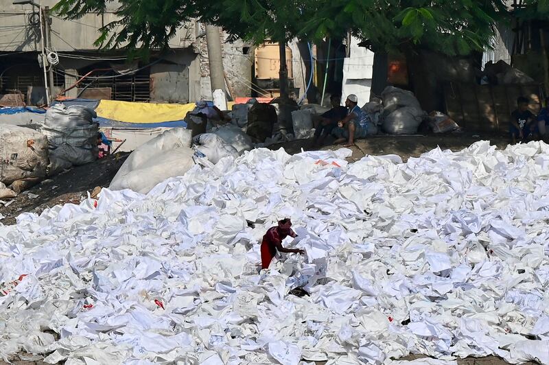 A workers sorts plastics for reuse near the Buriganga River in Bangladesh's capital Dhaka. AFP