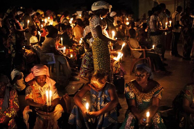 Catholic worshippers pray at the Saint Pierre Claver church in the Bacongo district of Brazzaville at the beginning of the Easter vigil. Marco Longaari / AFP