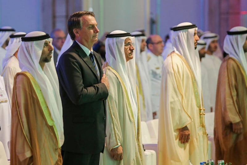 Brazilian President Jair Bolsonaro stands for the national anthem during the Brazil-United Arab Emirates Business Forum in the Emirati capital Abu Dhabi, on October 27, 2019.   / AFP / -
