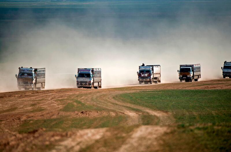 A convoy of trucks transport civilians fleeing the battered ISIS-held holdout of Baghouz in Syria. AFP