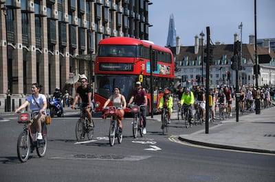 More cyclists are seen on the roads in Parliament Square as the lockdown due to the coronavirus outbreak continues, in London, Friday, May 8, 2020. The highly contagious COVID-19 coronavirus has impacted on nations around the globe, many imposing self isolation and exercising social distancing when people move from their homes.(AP Photo/Alberto Pezzali)