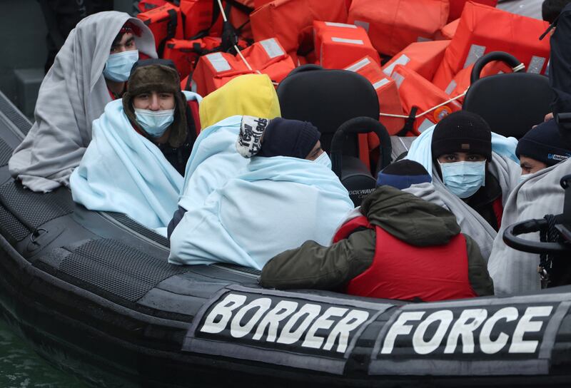 Migrants arrive at the Port of Dover on board a Border Force vessel after being rescued while crossing the English Channel. Reuters