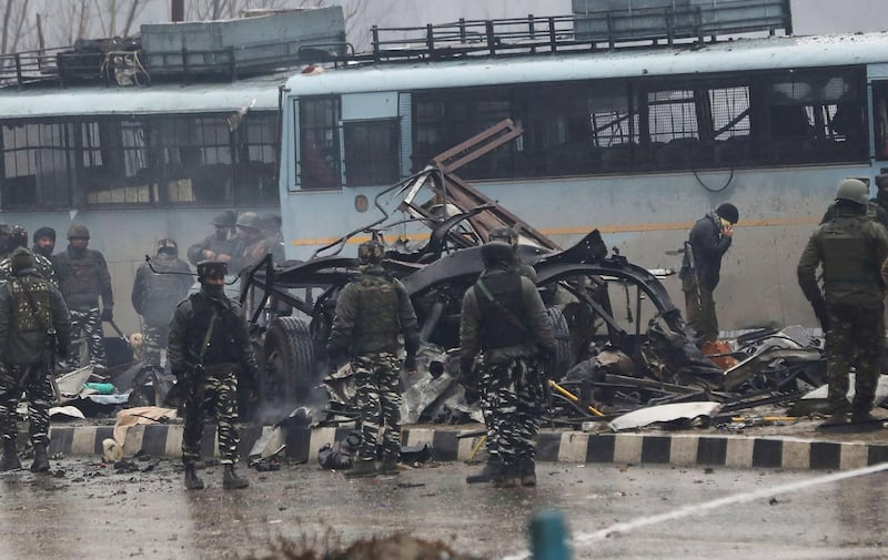 Indian security forces inspect the remains of a vehicle following an attack on a paramilitary Central Reserve Police Force (CRPF) convoy that killed at least 16 troopers and injured several others near Awantipur town in the Lethpora area of Kashmir about 30km south of Srinagar. AFP