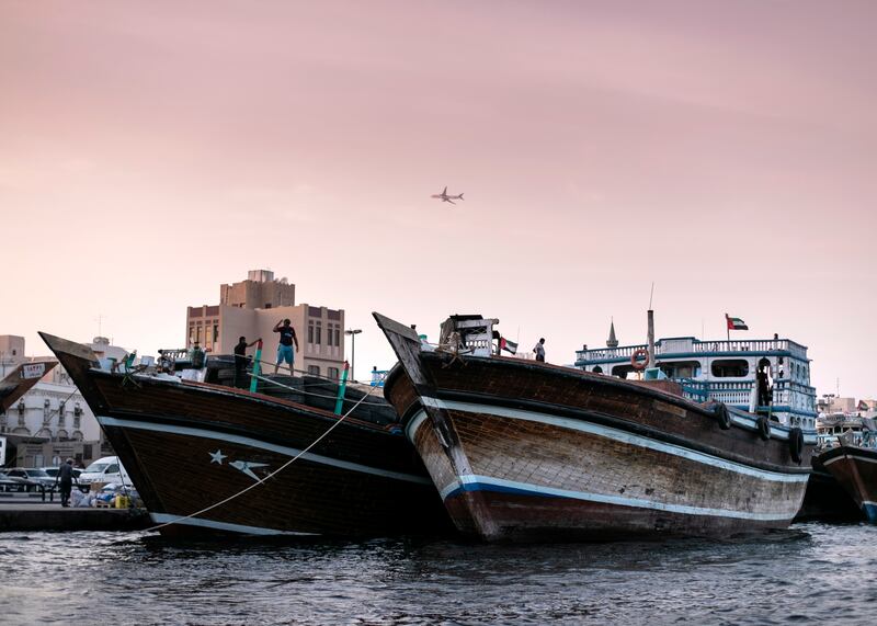 Dhows unloading and loading items by Deira's Spice Market. For many people, the creek [Khor] with its dhow moorings, Abra water taxis and souks is the very essence of the old city. For decades, Dubai Creek has been a hive of activity as traders bring in goods and sell their wares at the bustling markets nearby. Reem Mohammed / The National