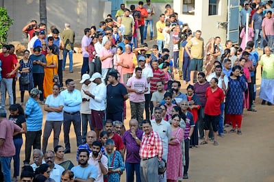 People queue up to vote during the second round of voting in the six-week long national election outside a polling booth in Bengaluru, India, Friday, April 26, 2024.  (AP )