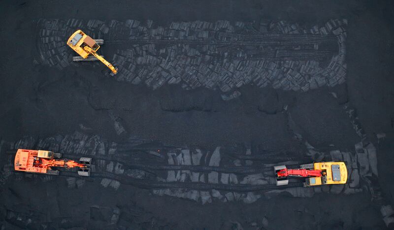 Excavators transfer coal at a port in Lianyungang in China's eastern Jiangsu province. AFP