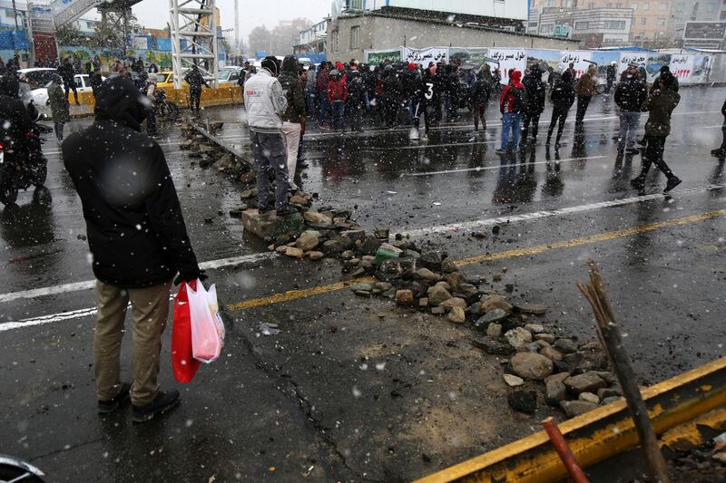 A road is blocked by protesters after authorities raised petrol prices, in Tehran. AP