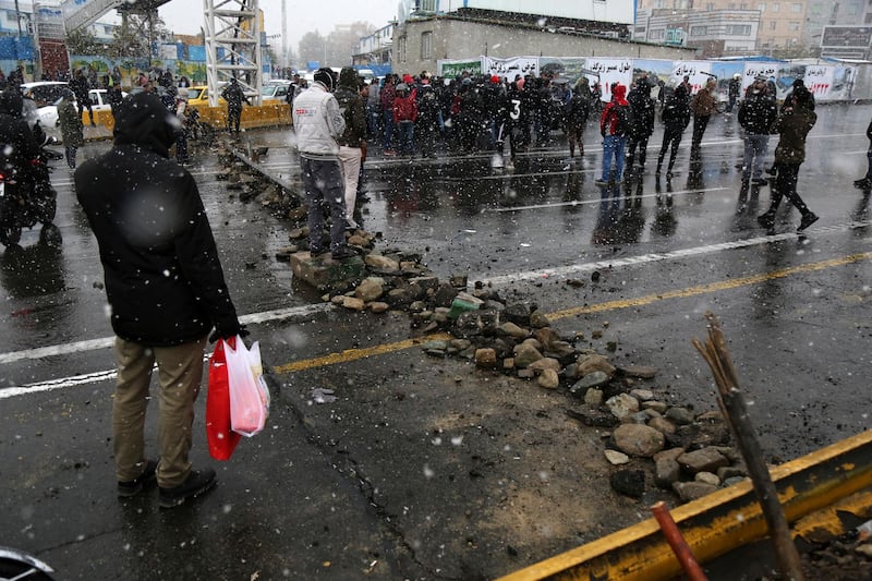 A road is blocked by protesters after authorities raised petrol prices, in Tehran. AP