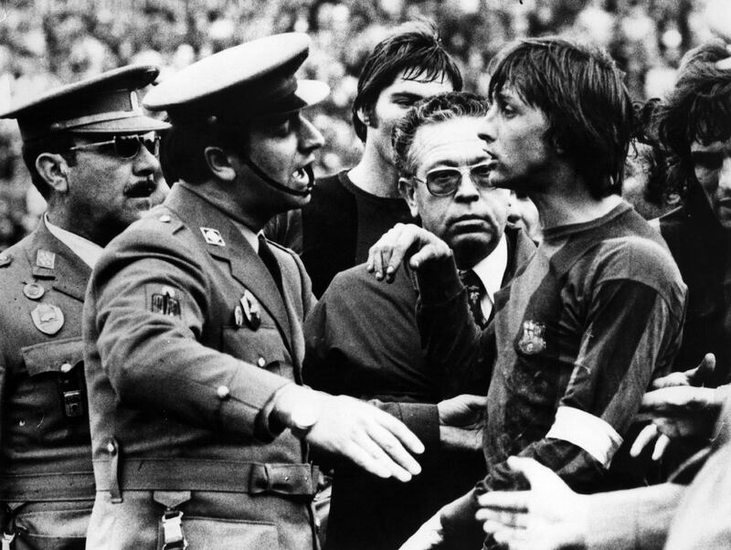 Johan Cruyff, captain of Barcelona, is escorted off the field  by police during the Barcelona Vs Malaga match in Malaga, for repeatedly opposing the referee's decision. Malaga eventually beat Barcelona 3-2.   (Photo by Central Press/Getty Images)
