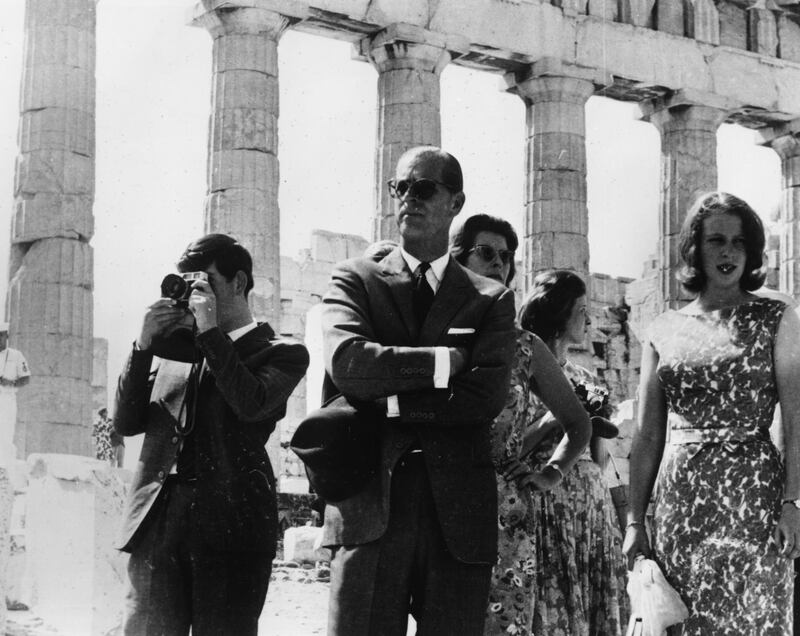 Prince Charles (left) taking a picture as he visits the Acropolis with the Duke of Edinburgh (centre) and Princess Anne, Greece, September 16th 1964. (Photo by Keystone/Hulton Archive/Getty Images)