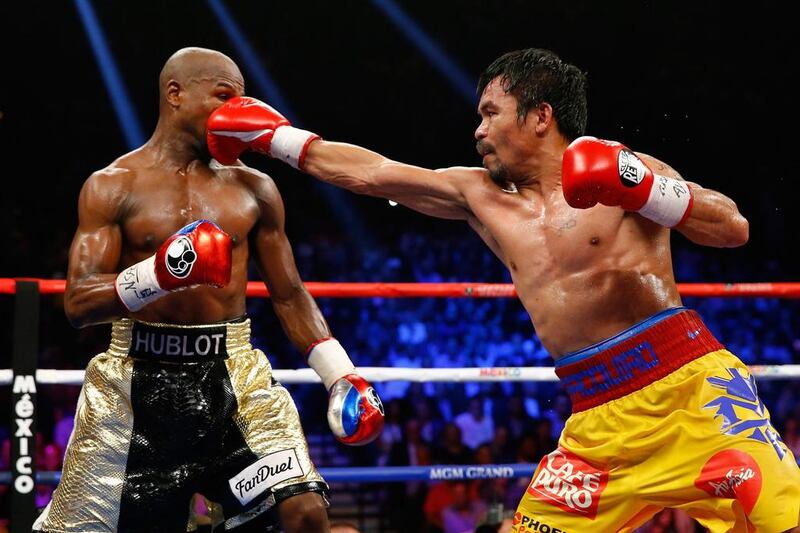 Manny Pacquiao lands a punch during his defeat to Floyd Mayweather. Getty