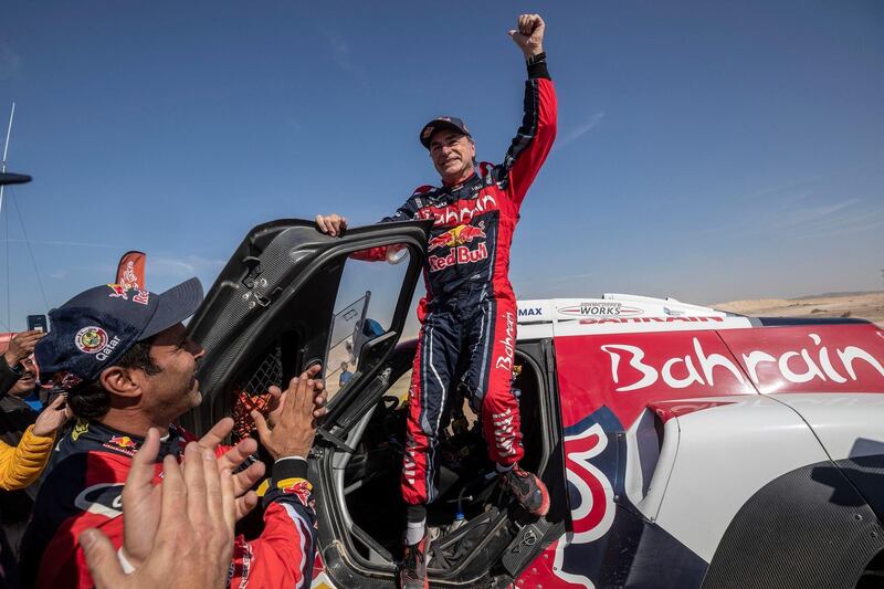Driver Carlos Sainz celebrates at the end of Stage 12. AP